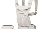 the baby carrier is white and has a pouch on the back