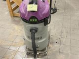 a purple wet dryer sitting on the floor in a room
