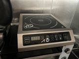 a stove top with an electronic burner on top of it