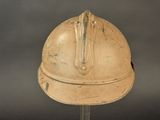 an old helmet on a stand on a gray background