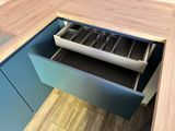 a drawer with utensils in it in a kitchen