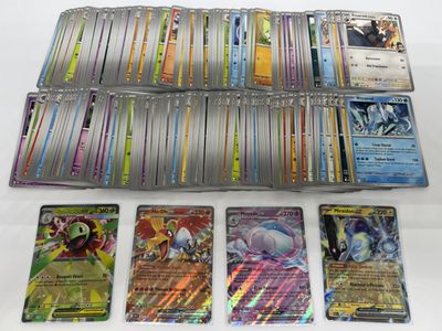 a lot of different pokemon cards on the table