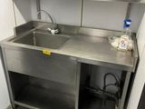 a kitchen with a sink and a counter in it