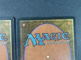 two decks of magic the gathering cards on a table
