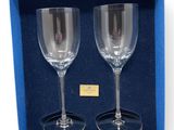 two empty wine glasses in a blue gift box on a white background