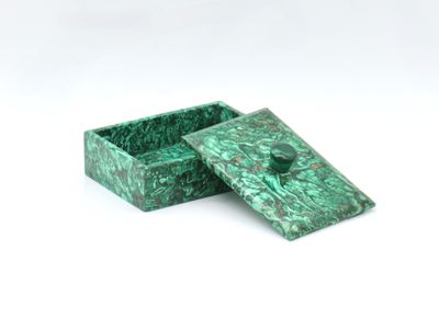 a green marble box sitting on top of a white surface