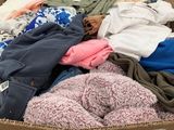 a cardboard box full of clothes on display in a store