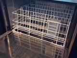 a dishwasher with a basket inside of it in a kitchen