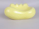 a yellow bowl with a cracky surface on it