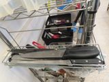 a metal rack with a knife and other kitchen utensils on it