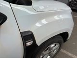a white truck parked in a parking lot next to other cars