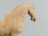 a statue of a horse with a saddle on it ' s back