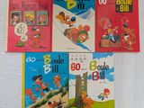 quatre livres pour enfants sont alignés sur une surface blanche