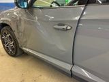 a car that has been badly damaged and is parked in a garage