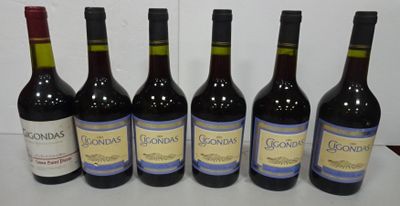six bottles of wine are lined up on a table
