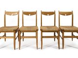 four wooden chairs are lined up against a white background