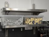 une étagère en métal sur laquelle sont disposés tout un tas de produits alimentaires