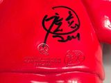 three red boxing gloves with chinese characters on them