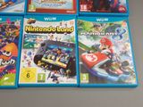 four nintendo wii games are sitting on a table next to each other