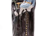 figurine of a saint holding a child in his arms