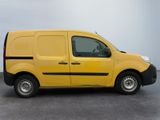 the yellow van is parked in a parking lot on a cloudy day