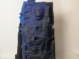 a blue sculpture on a white surface with a white background