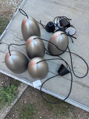 five silver balls sitting on a table with wires
