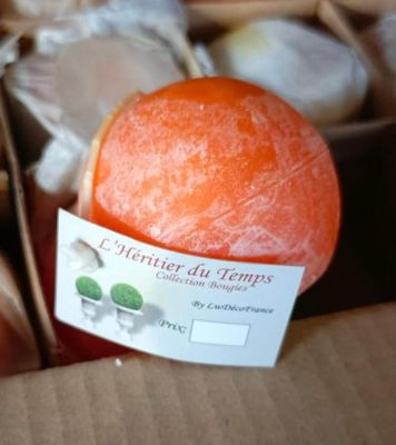 an orange in a box with a label on it
