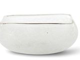 a white bowl that is sitting on a white surface