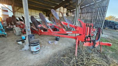 an image of a tractor and other farm equipment in a barn