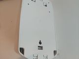 a white mouse sitting on top of a white surface