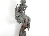 bronze statue of a winged bird with a crown on its head