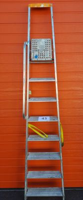a ladder that is leaning against a red wall