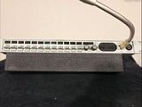 a microphone sitting on top of a keyboard on a table