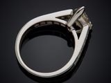 a close up view of a diamond ring on a black surface