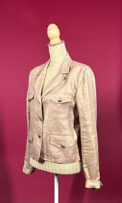 jacket on a mannequin stand against a red wall