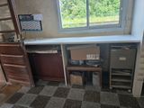 a room with a desk and a window in it