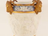 a white vase with a blue and gold decoration on it