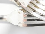 a fork and a spoon on a white surface