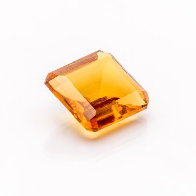 an orange topazte gems on a white surface
