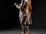 an image of a statue of a man standing next to a walnut nut