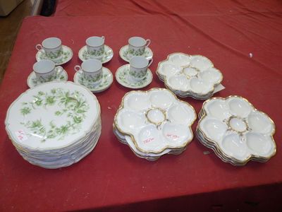 many plates and cups on a table with a red table cloth