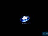an oval blue sapphire stone on a black background