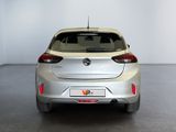 the rear end of a silver car in a white room