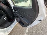 a white car with its door open in a parking lot