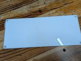 a white sign that is on a wooden table