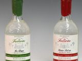 two bottles of liquor sitting next to each other on a white surface