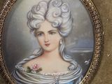 painting of a woman in a blue dress with a rose in her hair