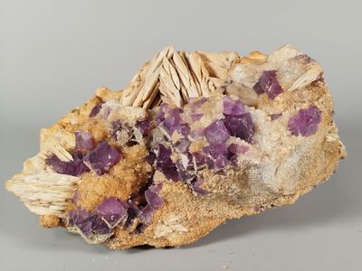 a close up of a rock with purple crystals on it
