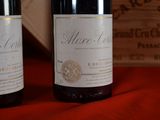 two bottles of wine sitting next to each other on a table